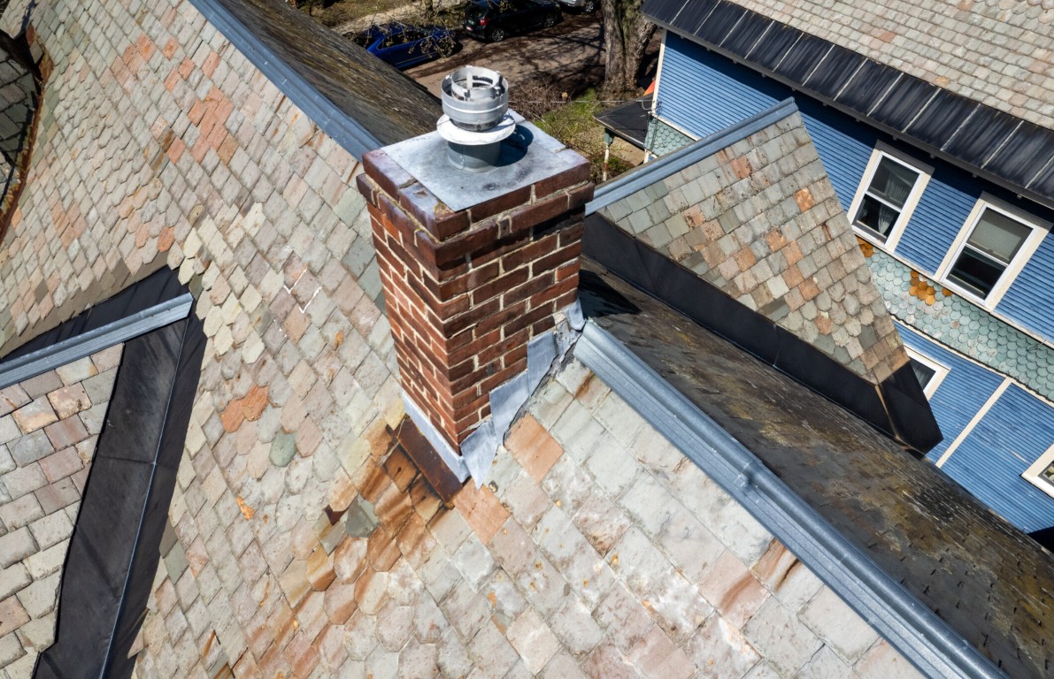 Expert chimney repair and rebuilding services on residential roof in McAllen, TX